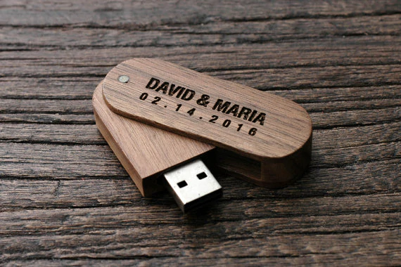 In questa foto una penna Usb di legno personalizzata con i nomi di due sposi e la data del loro matrimonio