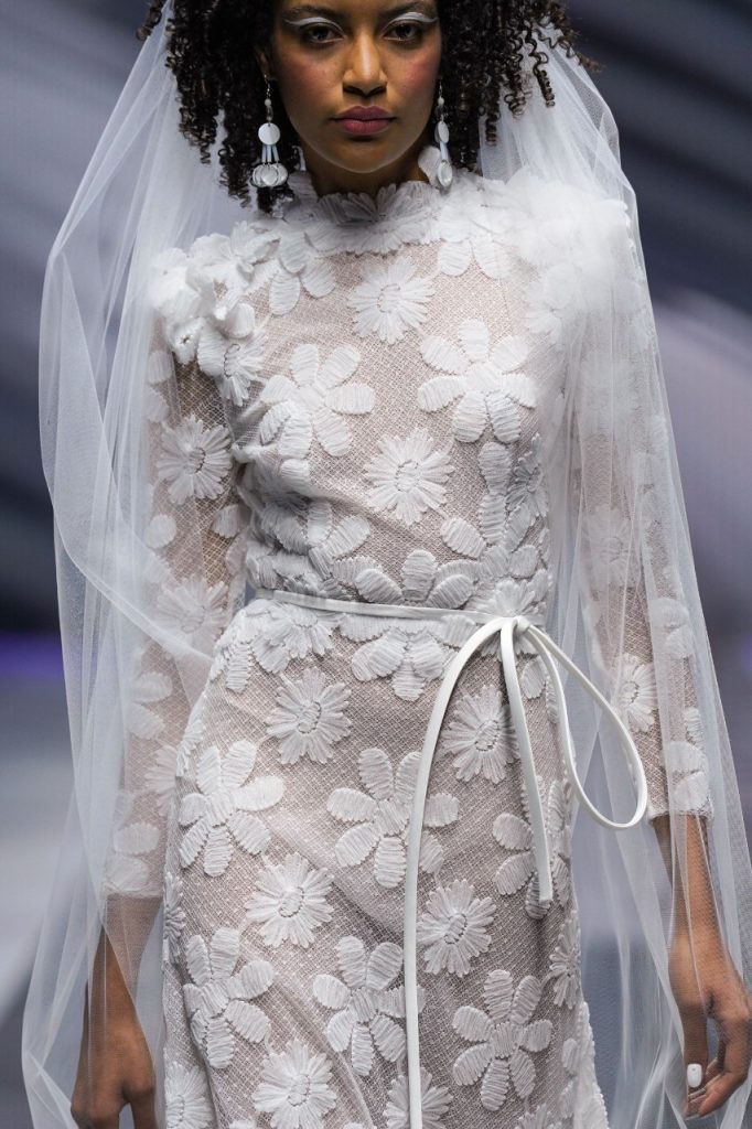 In questa foto la modella indossa un abito da sposa con fiori 3D di Elisabetta Polignano.