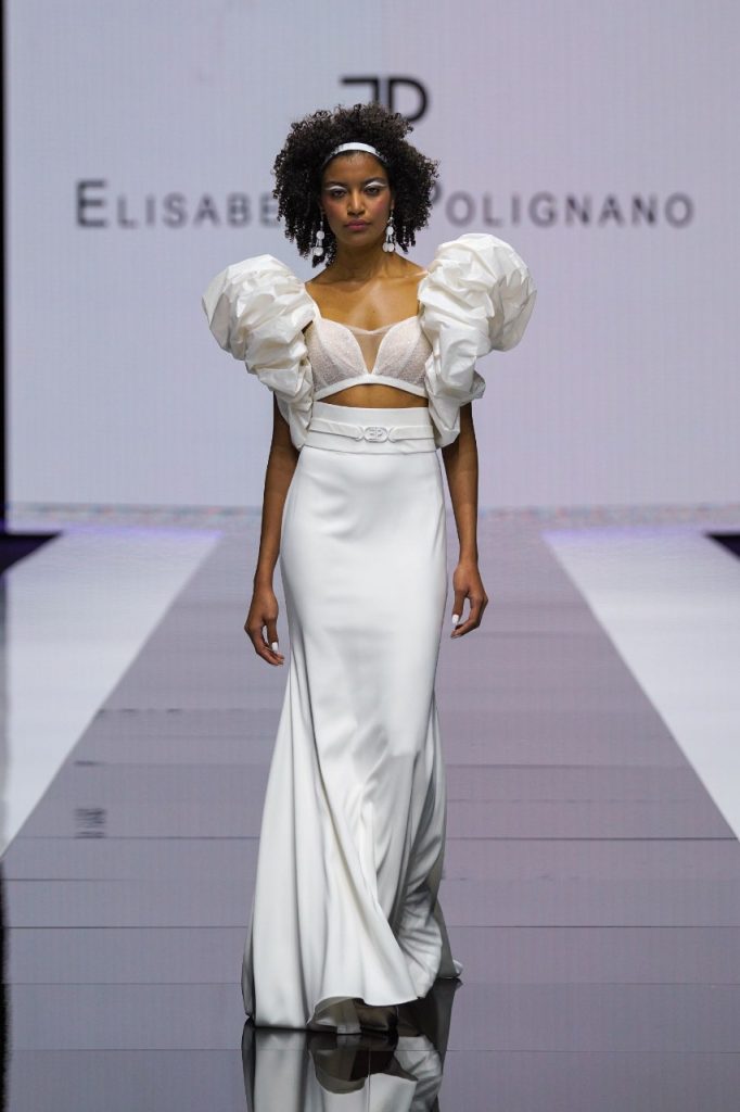 In questa foto la modella indossa un abito di seta Elisabetta Polignano 2023 con maniche realizzate con la seta stropicciata e gonna lunga.