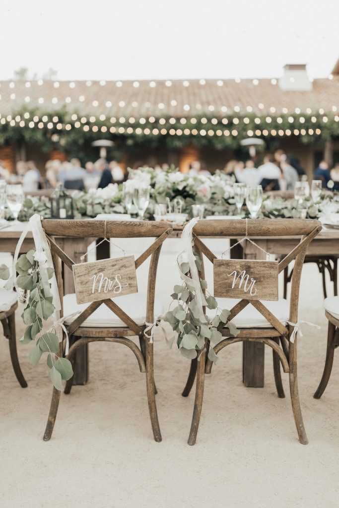 In questa foto idee matrimonio fai da te: pannelli per le sedie degli sposi con scritto Mr. e Mrs.