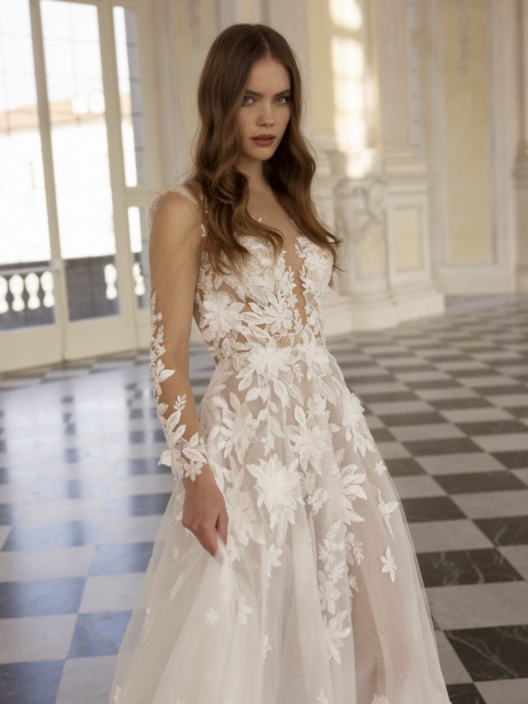 In questa foto un modello di abiti da sposa Capri 2023 con le maniche in pizzo
