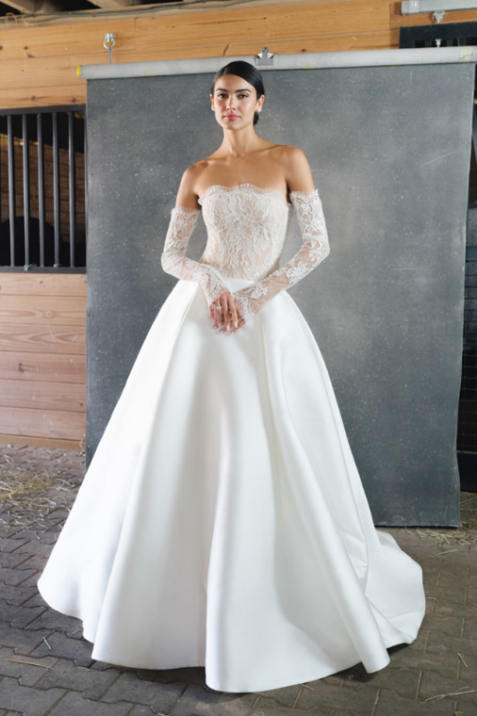 In questa foto una modella indossa un abito da sposa della collezione Anne Barge 2023