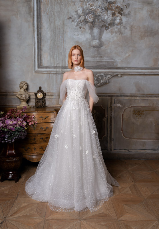 n questa foto una modella indossa un abito da sposa con applicazioni 3D sulla gonna della collezione Papilio 2023