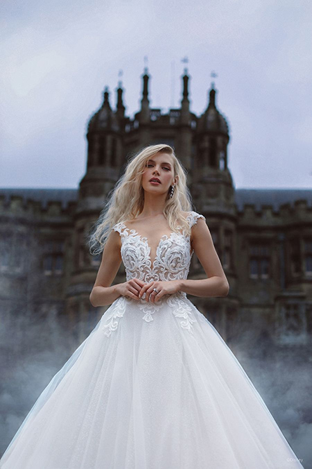 In questa foto la modella indossa un abito da sposa disney modello Cinderella con gonna di tulle e motivi barocchi nel corsetto