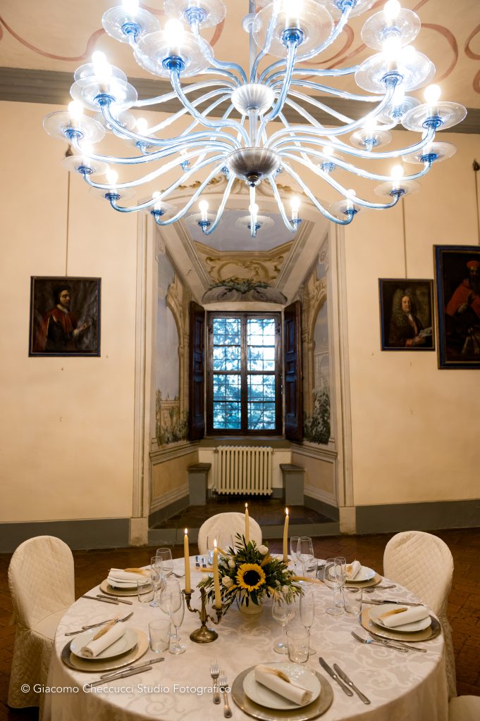 In questa foto la sala interna di Castello Oliveto allestita per un matrimonio di Wedding by Elisa: la mise en place con girasoli e spighe di grano