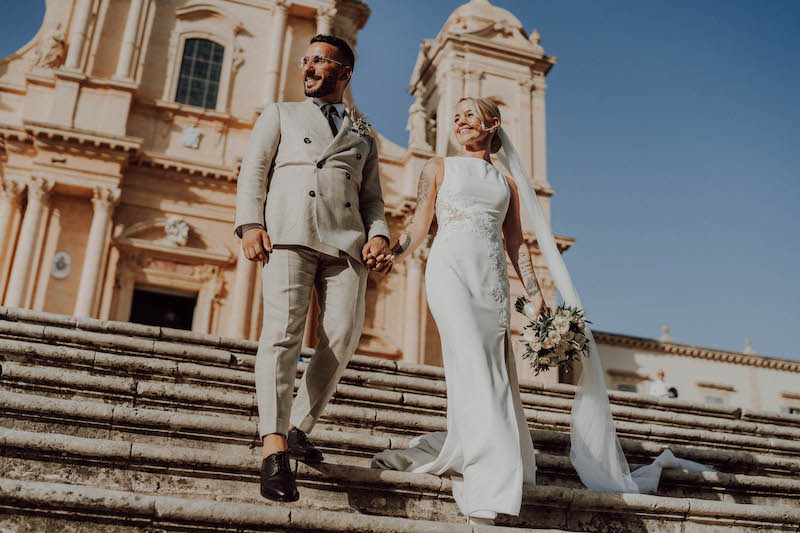 In questa foto dello Studio Santanastasio due sposi stranieri scendono la scalinata del Duomo di Noto