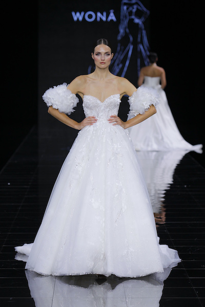 In questa foto una modella posa con un abito da sposa 2024 Wonà Concept