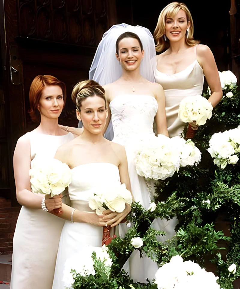 In questa foto un frame di Sex and the City con Carrie, Samantha e Miranda in abito da damigelle con Charlotte in abito da sposa dopo il matrimonio con Trey
