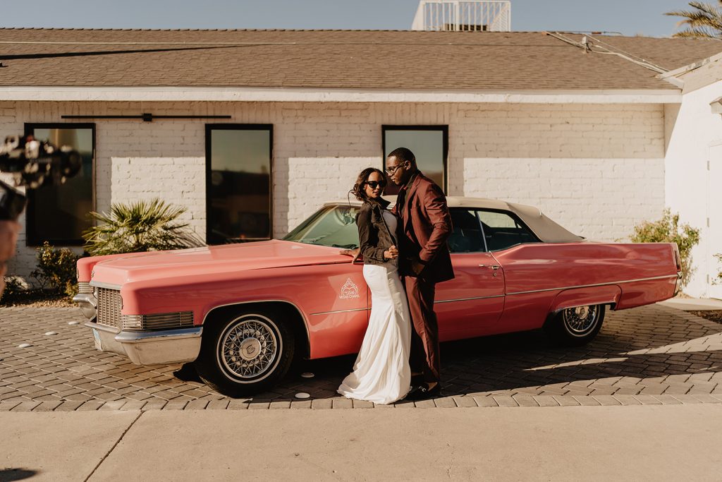 In questo scatto la coppia di sposi posa accanto ad una Cadillac rosa vintage
