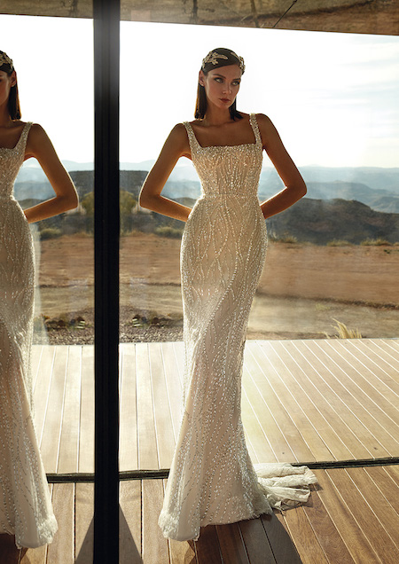 In questa foto una modella indossa un abito da sposa sirena con scollo quadrato, interamente ricoperto di micro perline sparkling 