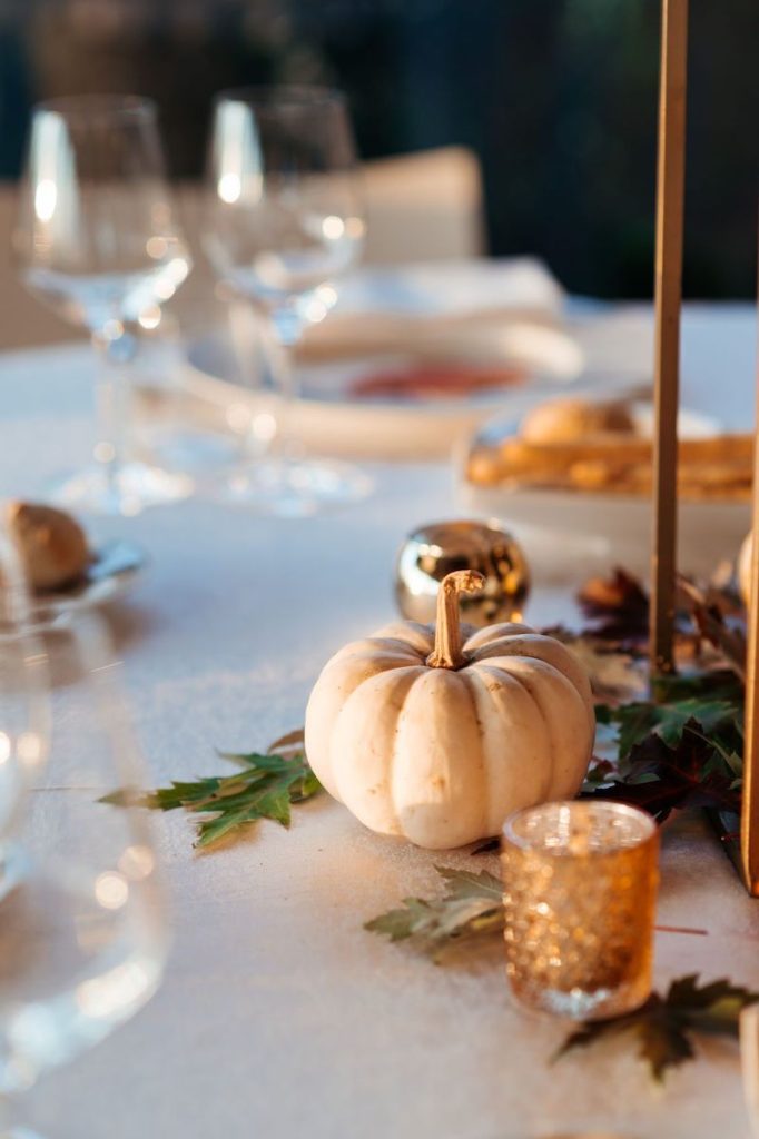 In questa foto il dettaglio di un centrotavola di un matrimonio a tema autunno realizzato con zucche e candele