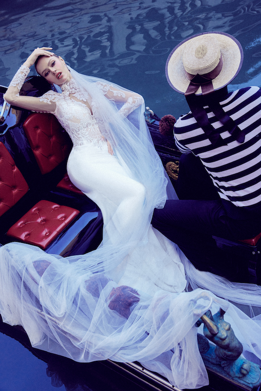 In questa foto una modella posa su una gondola venenziana con una sexy sirena di Maison Signore. Il vestito fa parte della linea Isabella