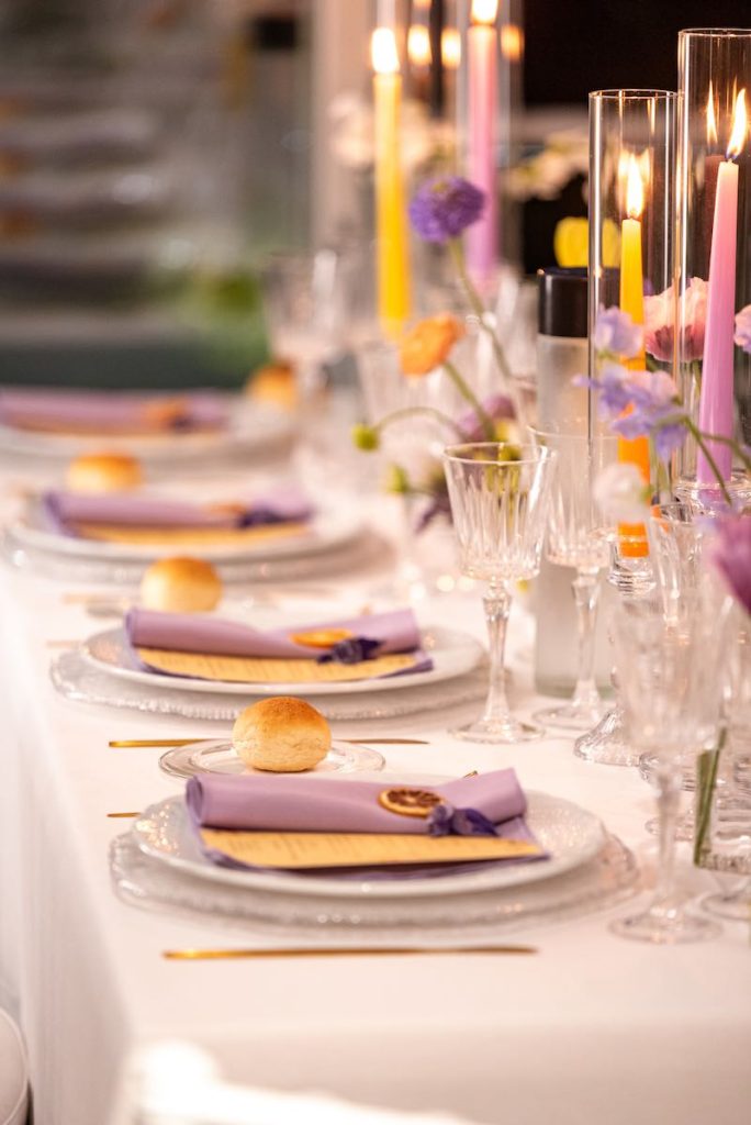 In questa foto il dettaglio di un matrimonio firmato dalla Wedding Designer Angela De Patto nei toni del lilla e dell'arancione con candele, tovaglioli e fiori en pendant