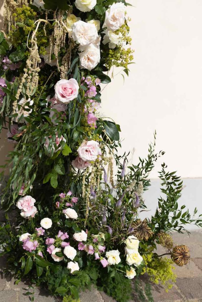 In questa foto il dettaglio dell'allestimento floreale dell'ingresso della chiesa per le nozze di Roberta e Domenico realizzato con rose di colore rosa e giallo