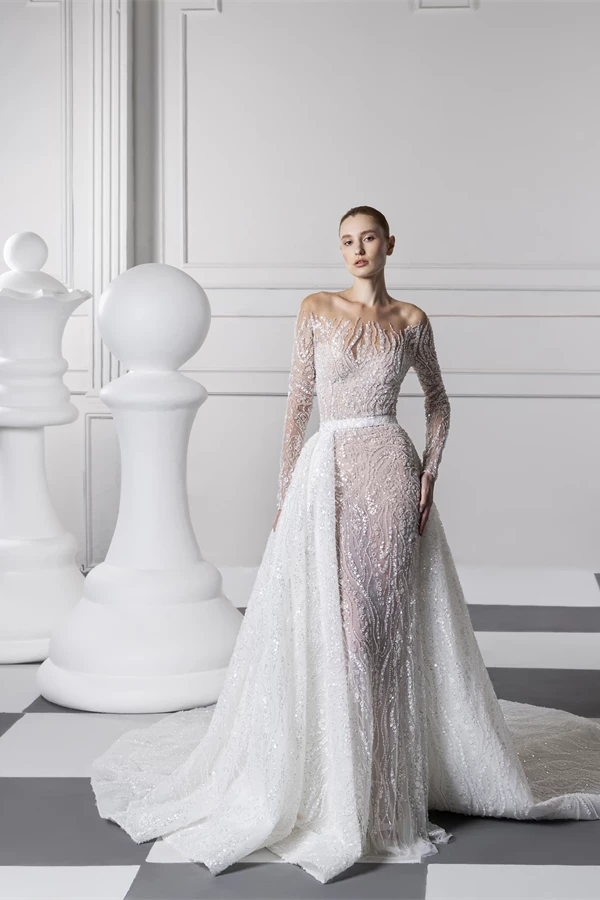 In questa foto la modella indossa un abito da sposa tony ward 2024 con ricami e sovragonna