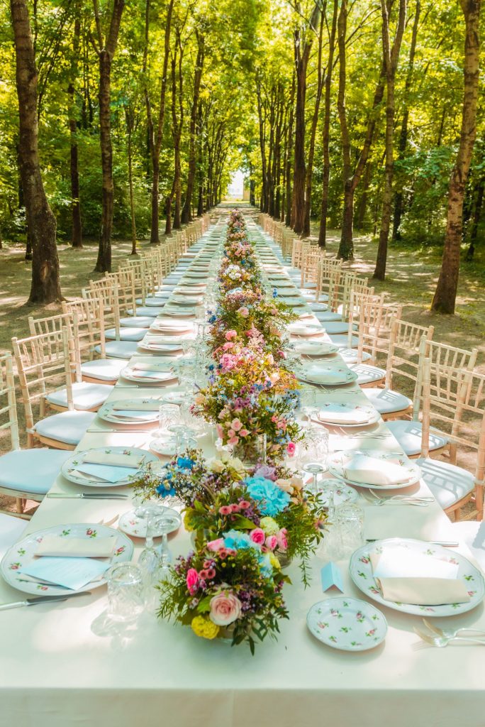 In questa immagine un allestimento di una location in un bosco. Eleganza firmata Paola Rovelli. 