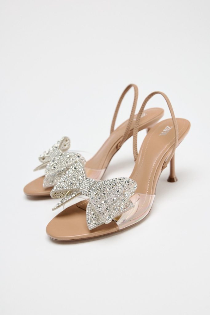 In questa foto, scarpe da cerimonia donna 2025 Zara modello sandalo trasparenti con fiocco gioiello sulla punta