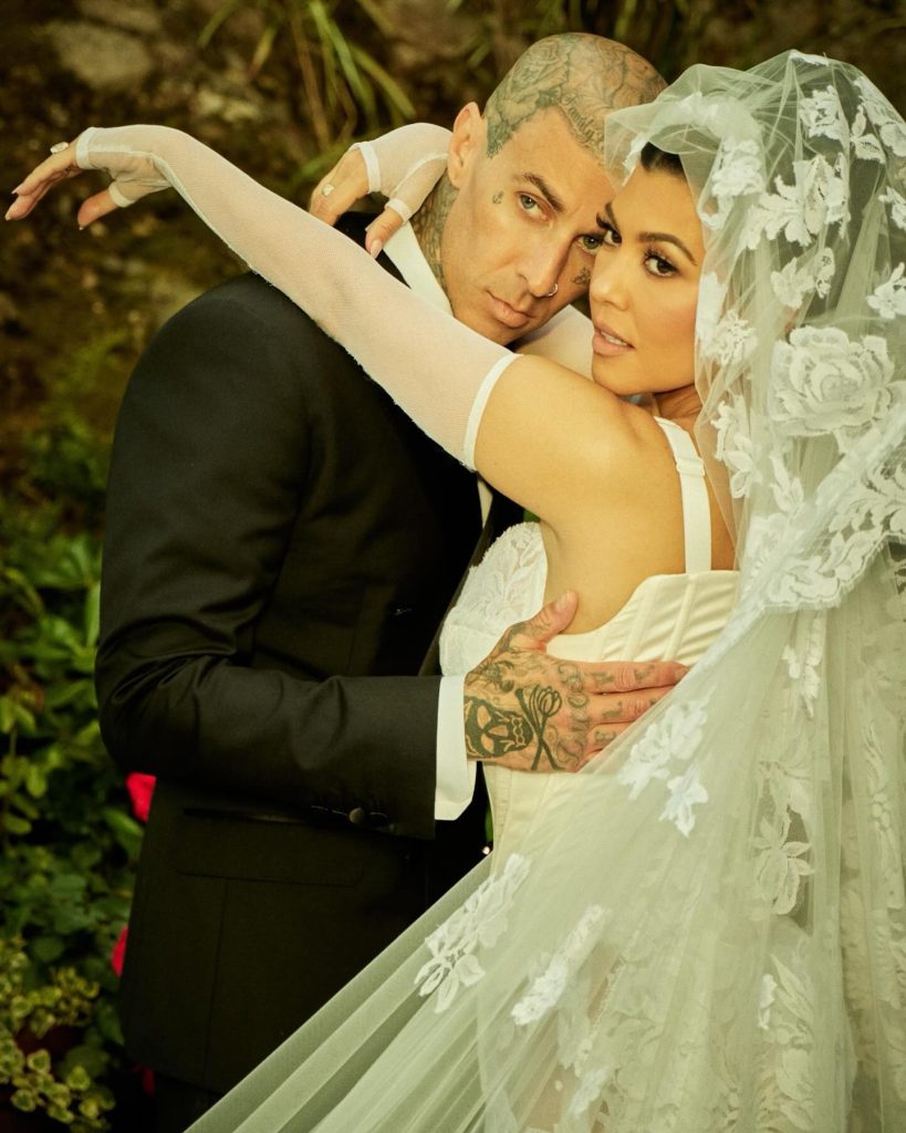 In questa foto Kourtney Kardashian il giorno delle nozze con uno chignon alto e velo ricamato 
