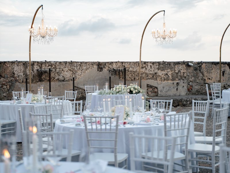 In questa foto, un ricevimento di nozze organizzato da Valeria Fazio nei toni del bianco e del rosa sulla Fortezza di Castelfranco. Lo spazio è decorato con chandelier di cristallo
