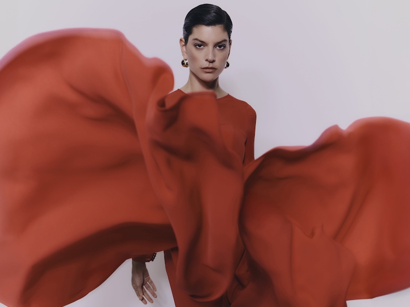 In questa foto una modella posa indossando uno degli abiti da cerimonia Pronovias 2026 di colore rosso