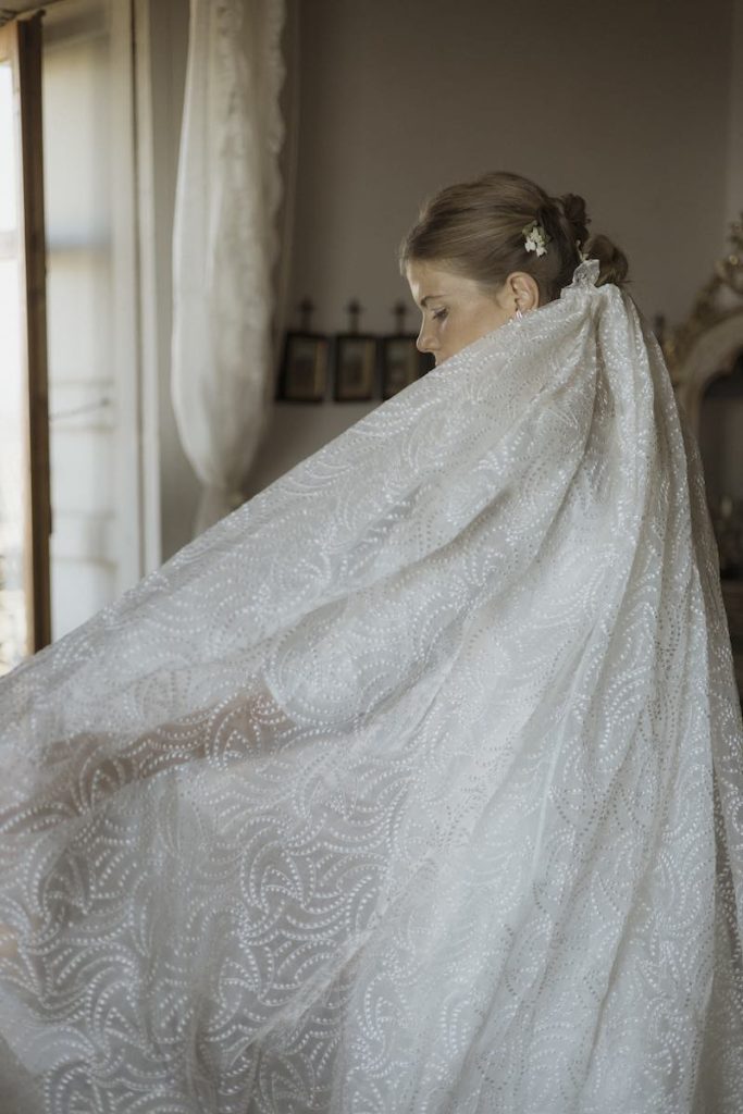 In questa foto, il dettaglio del velo disegnato dalla sposa e cucito e ricamato nel suo atelier Le Tre Sarte